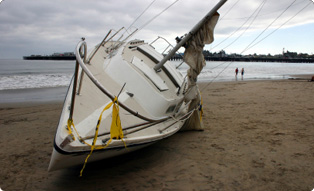 Sailboat on the sand near a lake